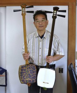 「リプル」を張った三味線を持つ小松社長