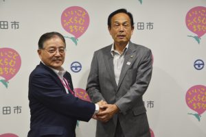東京五輪の協力に向けて握手を交わす両市町 